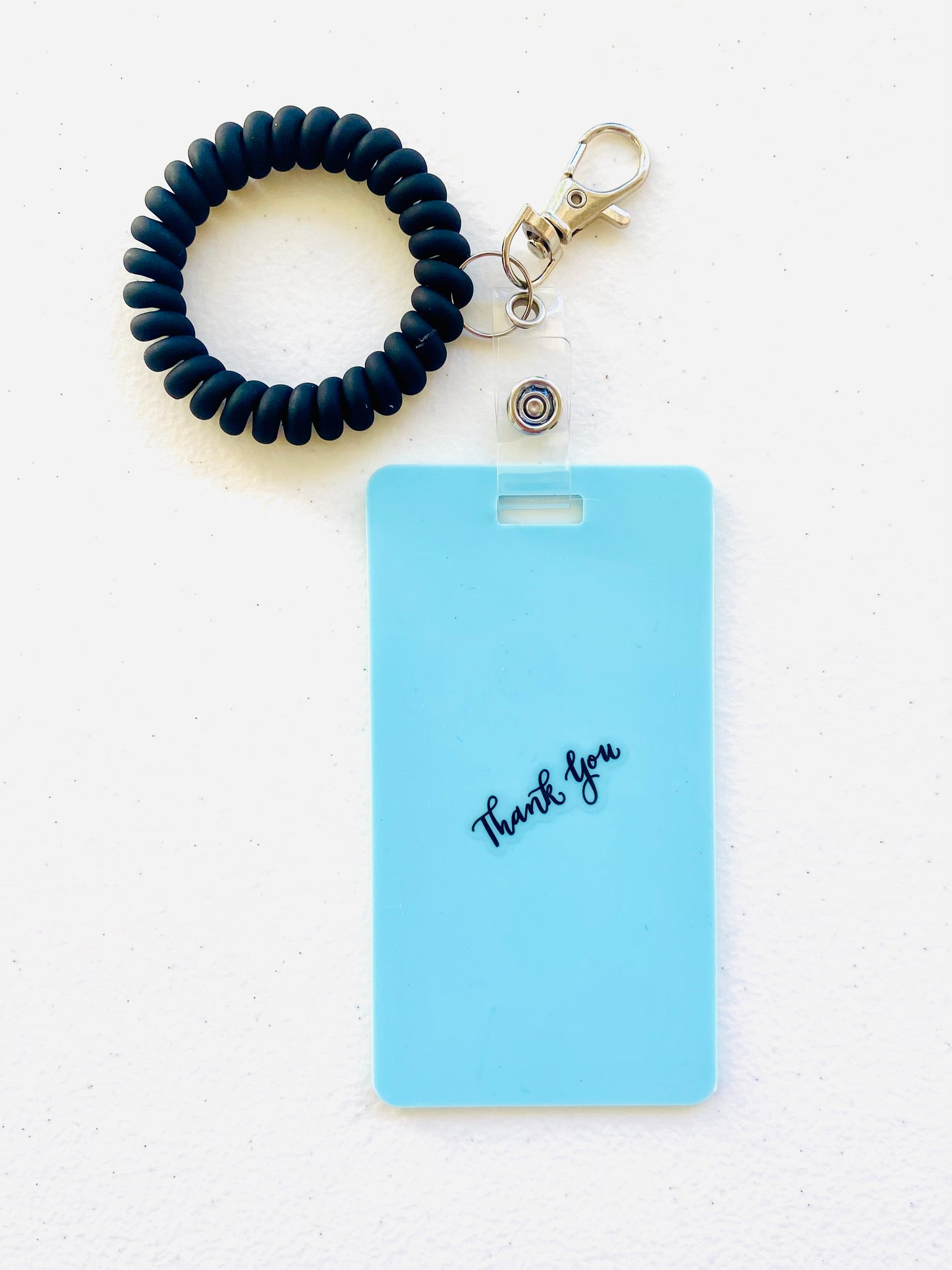 Keep your shopping list handy with this vertical reusable erasable badge note designed for keychains. Simply write using a ballpoint pen, erase with an alcohol pad, and reuse as needed. It easily clips onto your keys or purse, ensuring your list is always within reach. Please note, gel & super smooth/color ballpoint inks could leave faint marks. This practical accessory offers a reliable way to stay organized on the go. www.badgenote.com