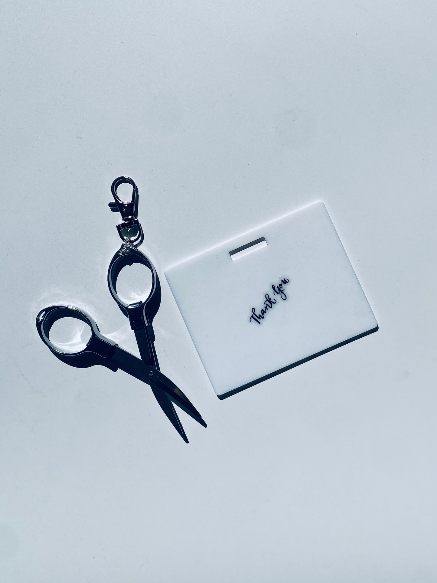 Horizontal erasable badge with mini Scissors is the perfect pocket-sized accessory for healthcare professionals. Easily write on it with ballpoint pen, wipe it clean with alcohol pad, and reuse. Made of lightweight soft silicone, it's a nurse's essential for taking notes on the go. Attach it to your ID badge for convenience. ATTENTION: Gel & super smooth/colored ink will smudge and may leave faint stains. www.badgenote.com