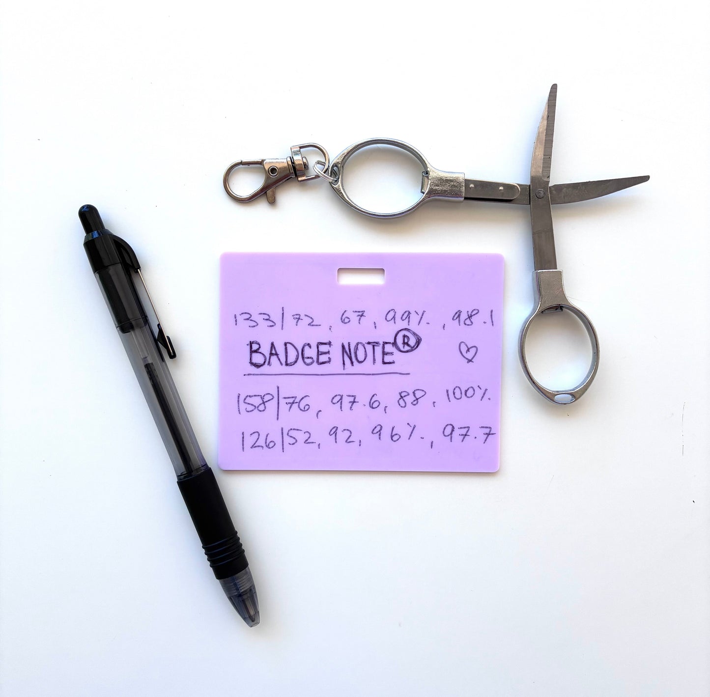 This practical badge note bundle pairs a horizontal design with a ballpoint pen (black ink) and compact folded scissors—ideal for healthcare professionals, educators, and office environments. The reusable surface accepts standard ballpoint ink and wipes clean with an alcohol pad for repeated use. Note that gel and certain smooth ballpoint formulations may leave residual marks; we recommend testing your preferred pen before regular use to ensure optimal performance and appearance. BADGENOTE.COM