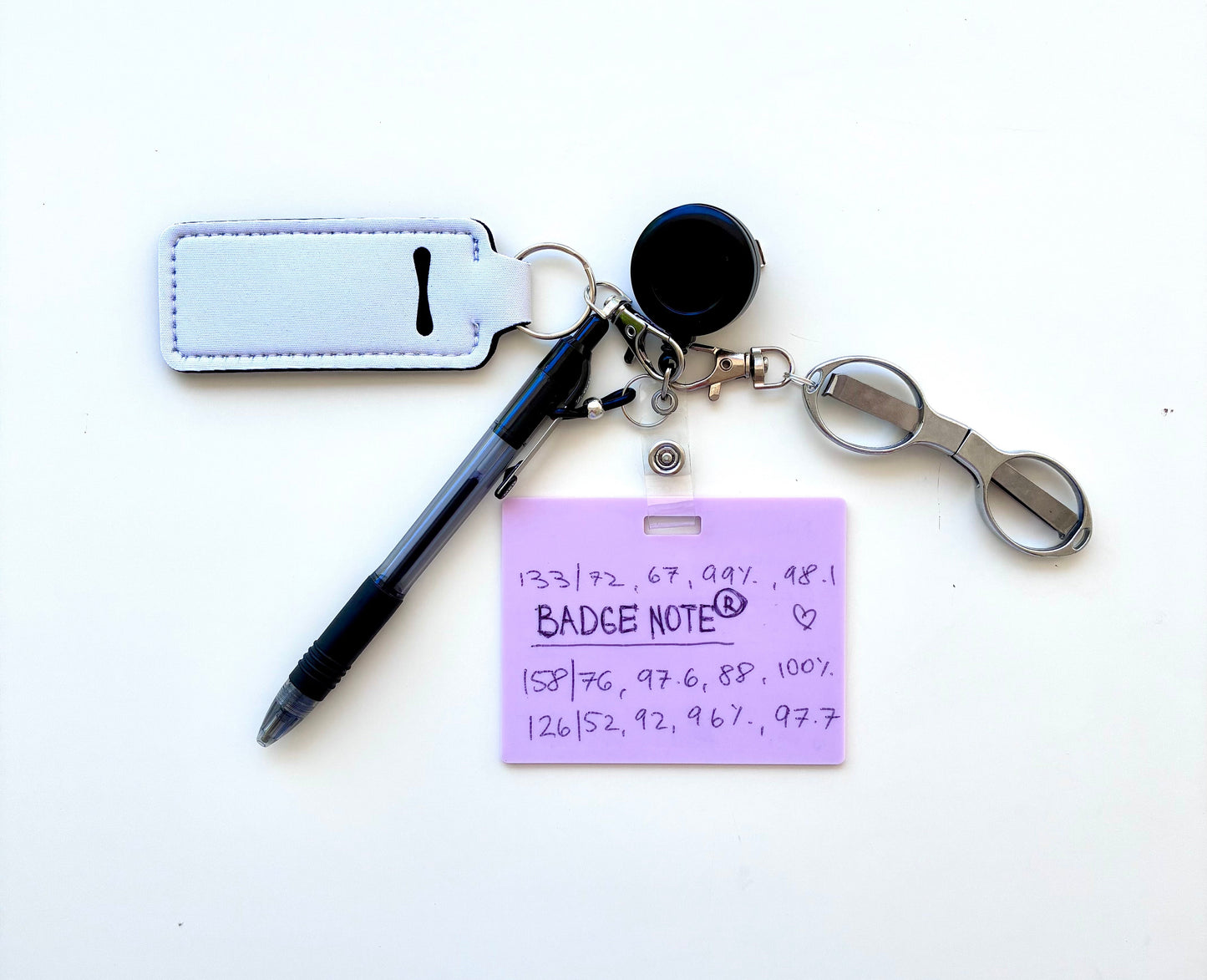 Erasable, reusable badge note with mini scissors, ballpoint pen, chapstick holder all attached to badge reel. Complete set gift idea for healthcare professionals, educators, office staff and more. BADGENOTE.COM