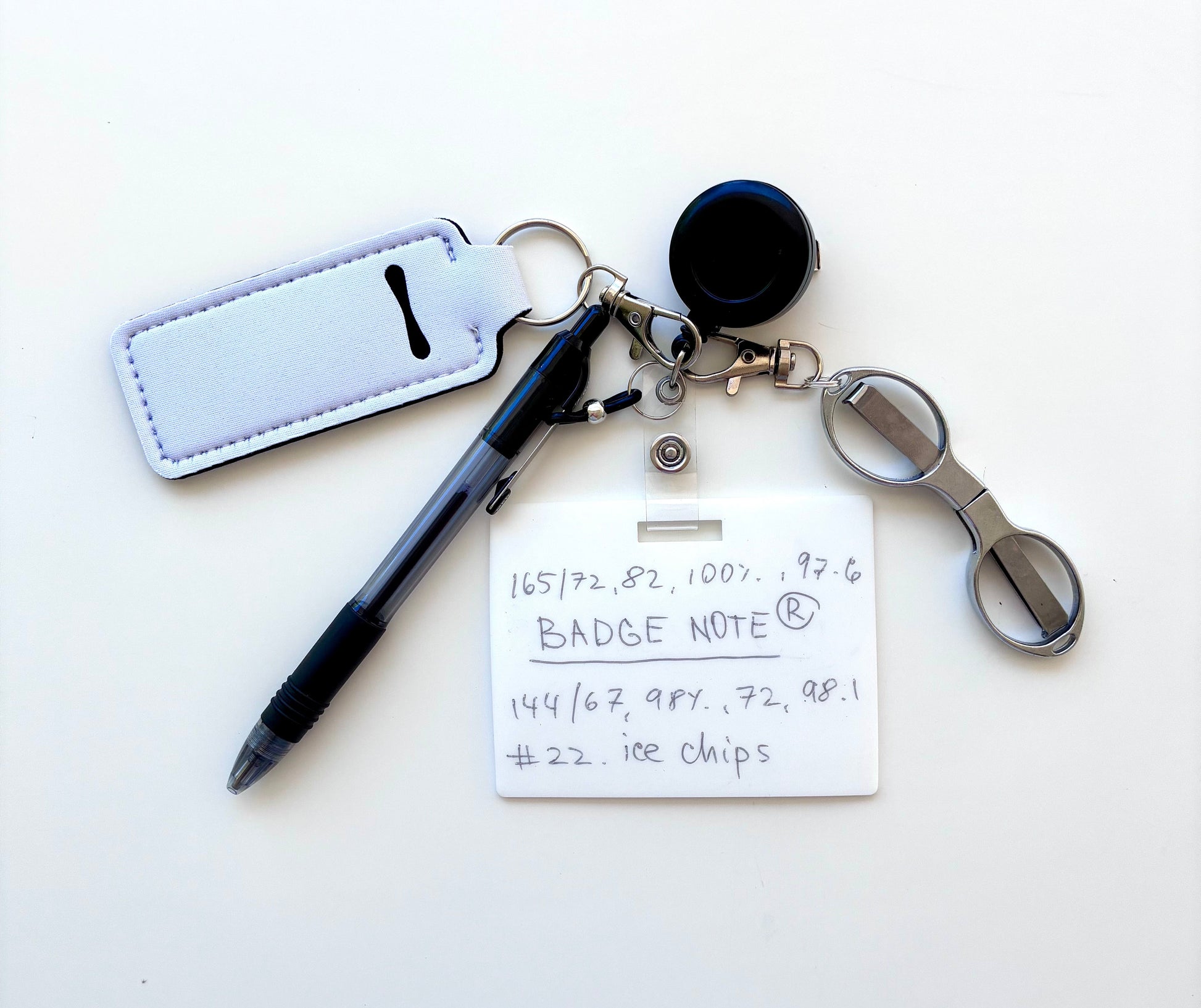 Erasable, reusable badge note with mini scissors, ballpoint pen, chapstick holder all attached to badge reel. Complete set gift idea for healthcare professionals, educators, office staff and more.BADGENOTE.COM